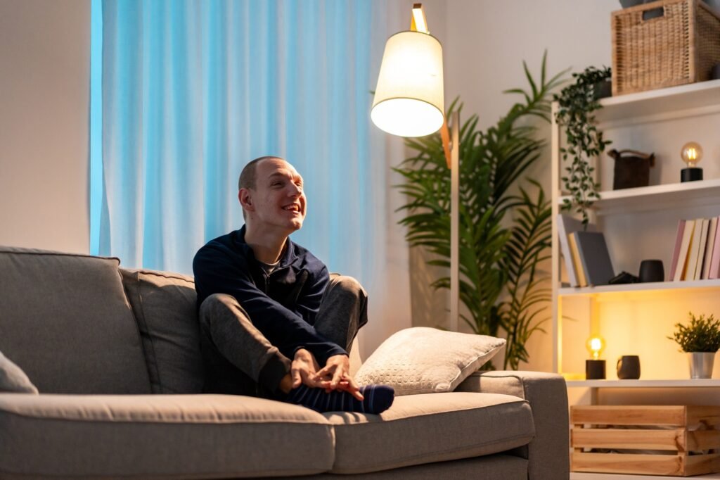 Disabled man feeling lonely sitting on the sofa at home